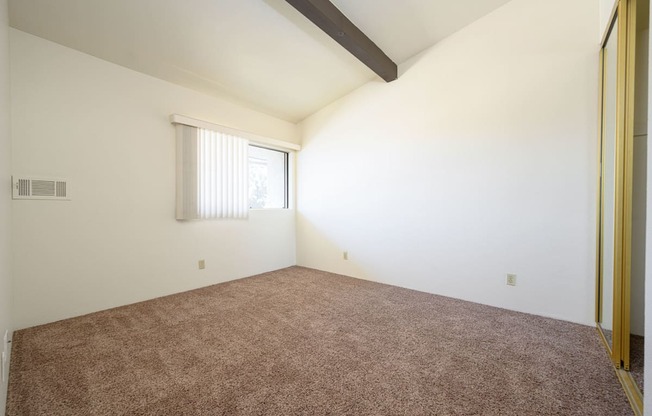 a bedroom with white walls and carpet at Park Columbia Apts, Hemet, 92544