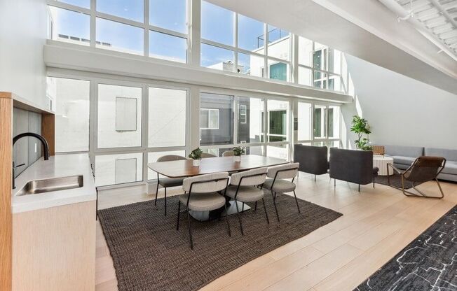 Community kitchen space with large sun windows at TL Residences