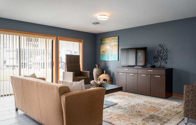 a living room with blue walls and a sliding glass door