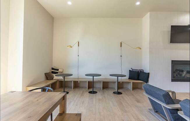 A modern living room with a wooden table and blue chairs at Northplace Apartment Homes, Salem, OR, 97305