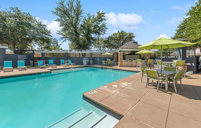Community Swimming Pool with Pool Furniture at Allure North Dallas Apartments in Dallas, TX.
