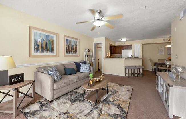 a living room with a couch and a ceiling fan