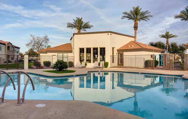A pool with a building behind it.