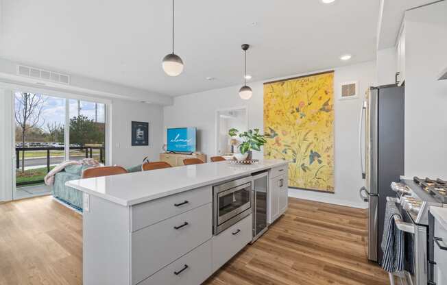 a kitchen with a white counter top and a refrigerator