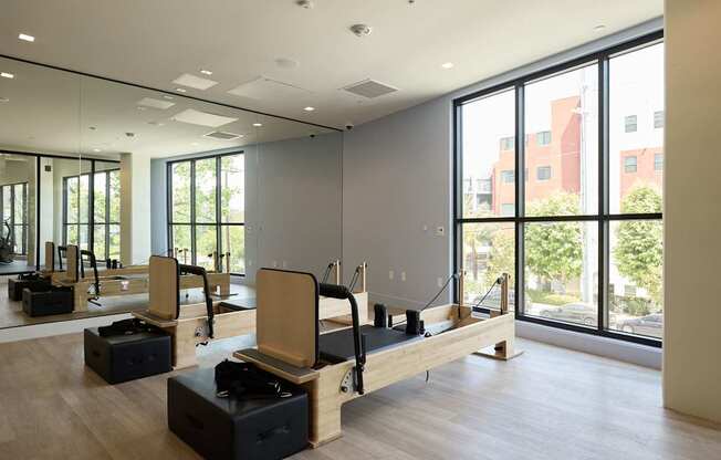 A room with wooden floors and mirrors on the wall.