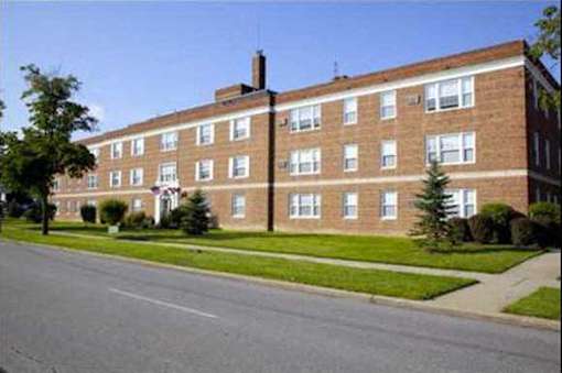 Building with a green lawn in front.