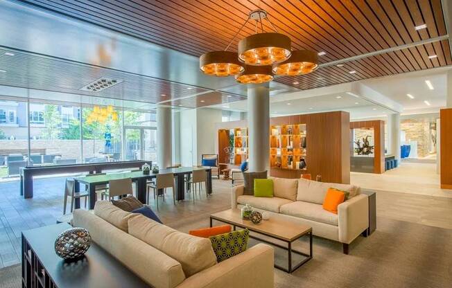 A modern living room with a wooden ceiling and a large window.