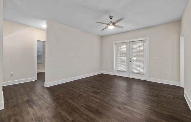A room with wooden floors and a ceiling fan.