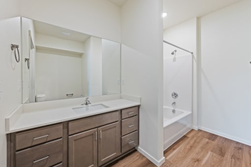 a bathroom with a large mirror and a sink and a shower at Gateway Apartments, East Wenatchee ,Washington, 98802