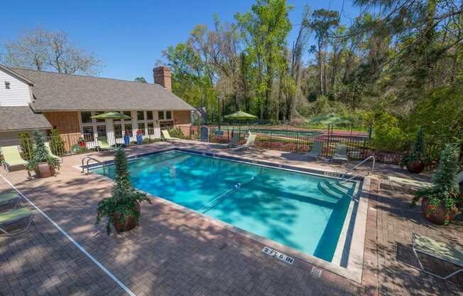 a swimming pool with a house in the background