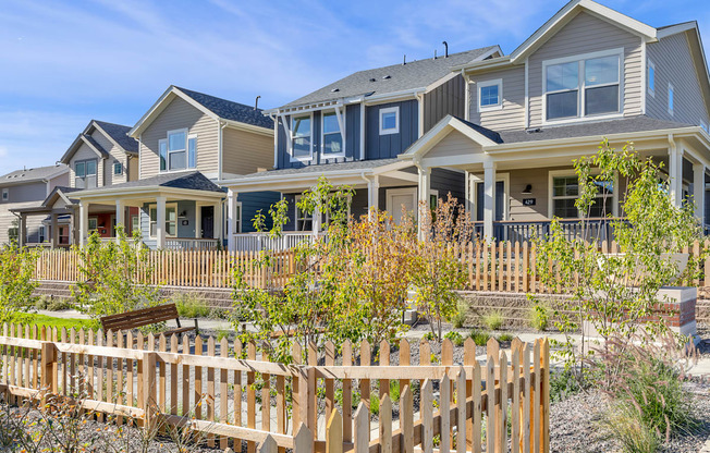 a row of houses with a wooden fence