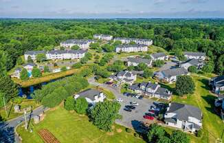 A bird's eye view of a residential area with houses and a river.