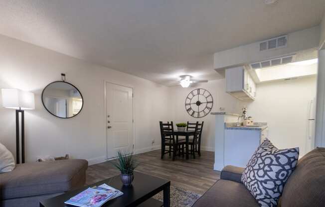 This is a photo of the living room and dining area of the 515 square foot 1 bedroom apartment at Canyon Creek Apartments in Dallas, TX
