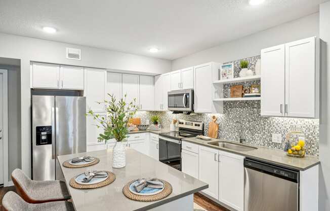 a kitchen with stainless steel appliances and white cabinets