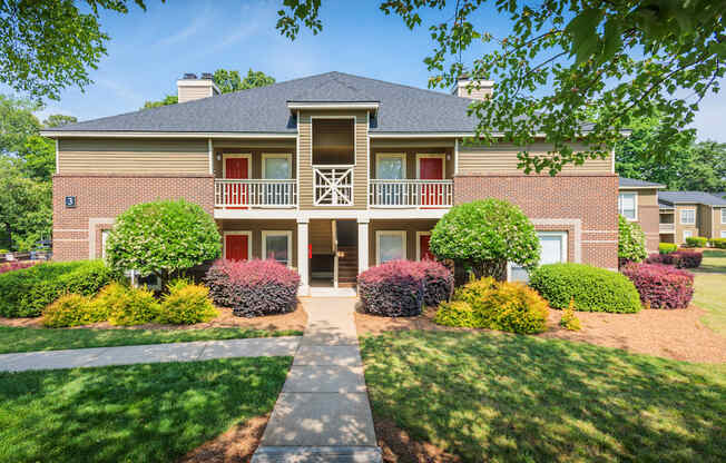 Apartment Building Surrounded By Lush Landscaping