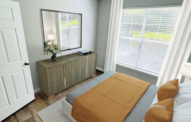 A bedroom with a bed, dresser, and mirror.