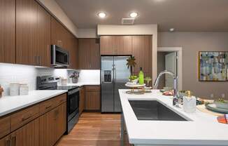 A modern kitchen with wooden cabinets and stainless steel appliances.