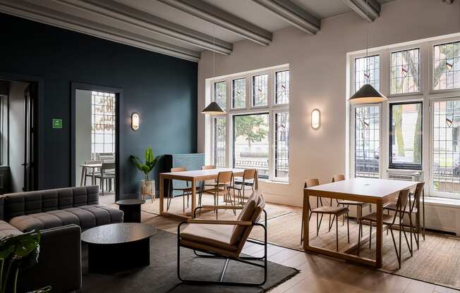 a living room with tables and chairs and a large window