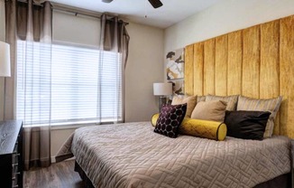 a bedroom with a large bed and a window