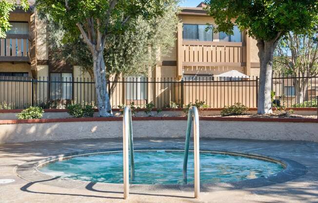 a small swimming pool in front of an apartment building