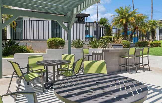 Outdoor BBQ Area with Canopy and Picnic Tables at Fullerton Hills Apartments located in Fullerton, CA.
