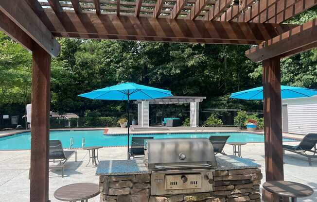 Place at Midway Douglasville GA a pergola with a grill and umbrellas overlooking a swimming pool