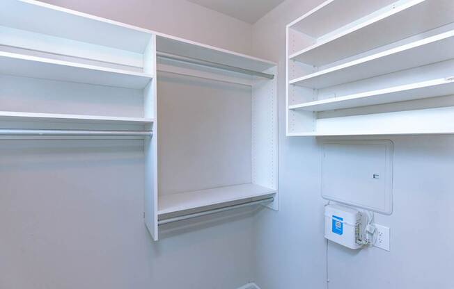 Empty white shelves in a room.