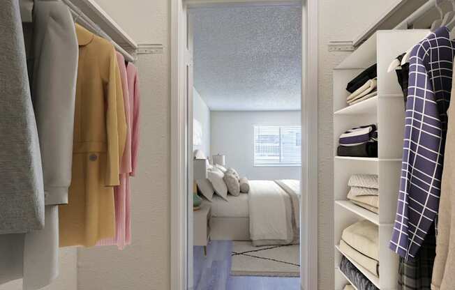 A bedroom with a bed and a closet with clothes.