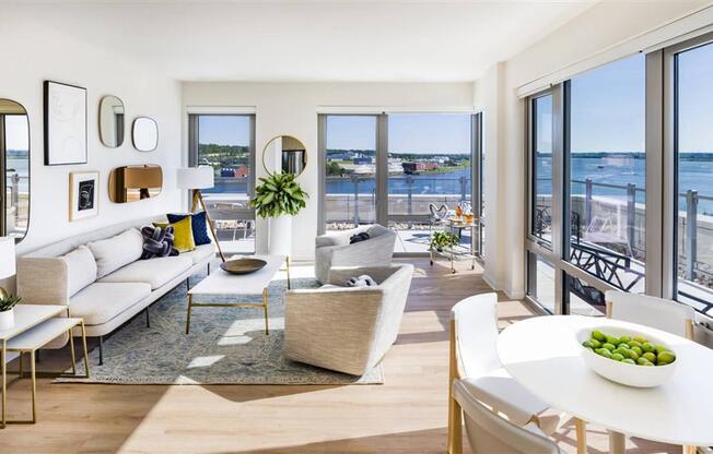 RiverPoint apartments penthouse living and dining areas with floor to ceiling windows and sweeping waterfront views