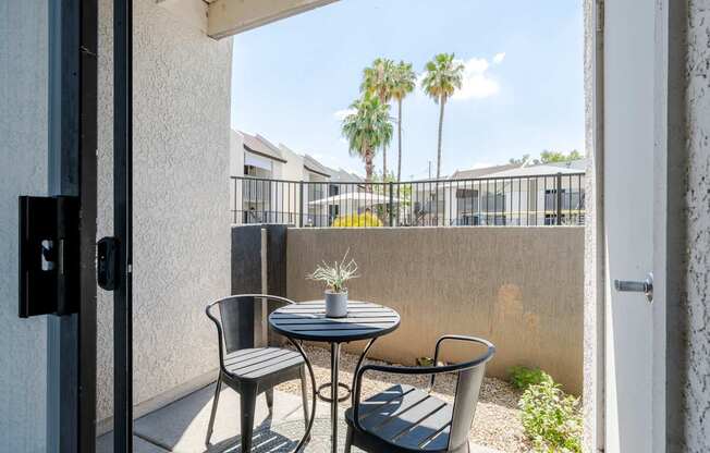 A patio with a table and two chairs.