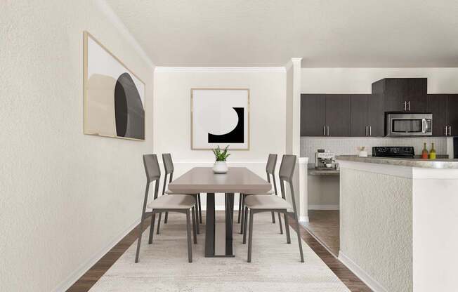 A dining table with chairs and a framed picture on the wall.