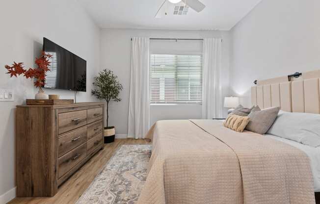 a bedroom with a bed and a tv