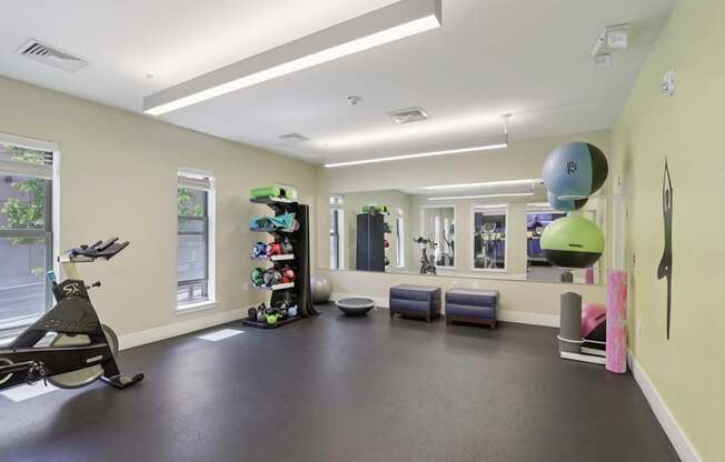 A room with a treadmill and exercise equipment.