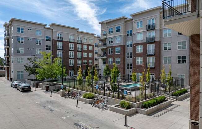 an empty parking lot in front of an apartment building