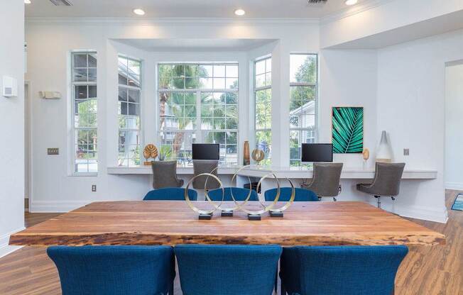 A dining room with a wooden table and blue chairs.