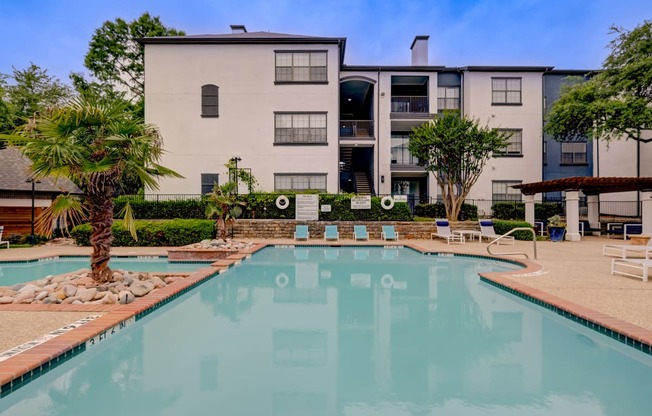 a swimming pool with a building in the background