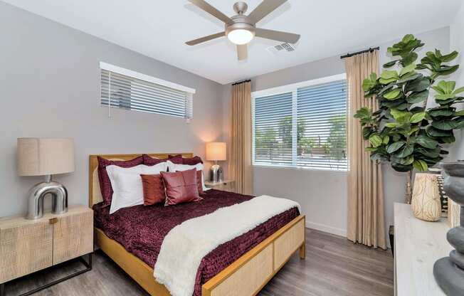 a bedroom with a bed and a ceiling fanat Weylyn Luxury Apartments, Laveen, 85339