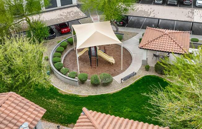 an aerial view of a playground in the yard of a house