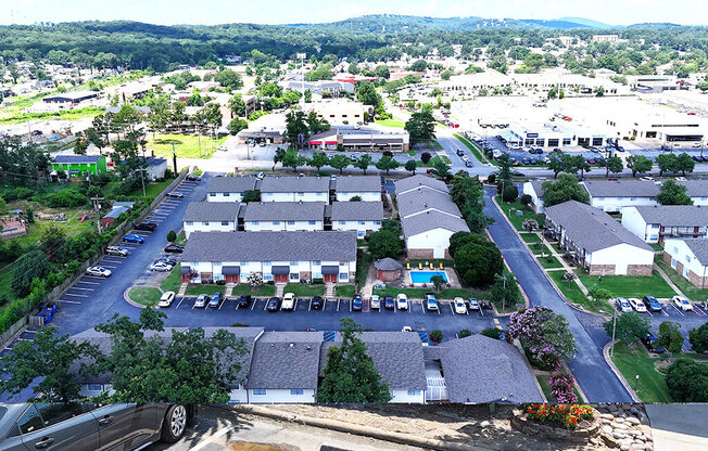A parking lot is in the foreground of a residential area.