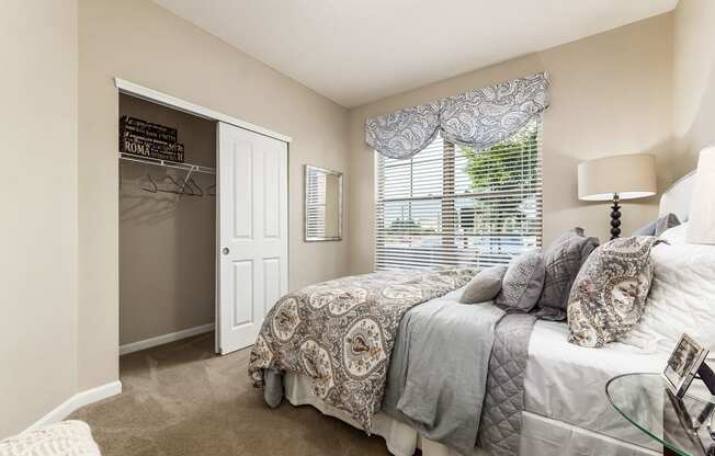 bedroom with view of closet in apartment