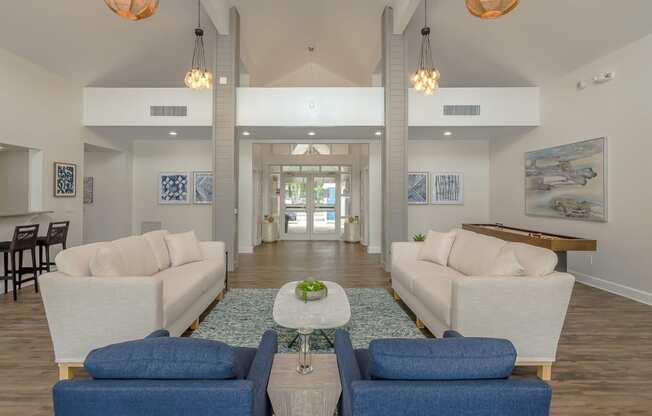 a living room with couches and chairs and a table