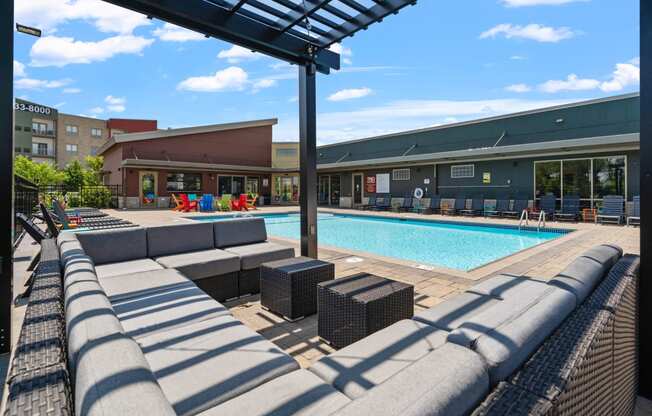 a swimming pool with lounge chairs at TRIO @ Southbridge apartments