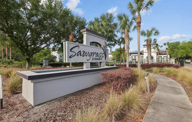 A sign that says SavvyGlass in front of some trees.