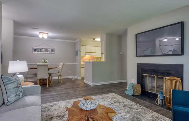 a living room with a fireplace and a table with chairs