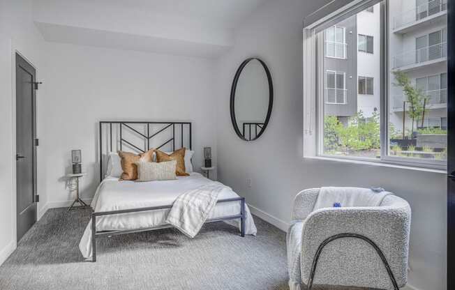 a bedroom with a bed and a chair in a 555 waverly unit