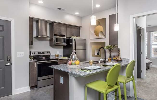 a kitchen with a bar and green stools