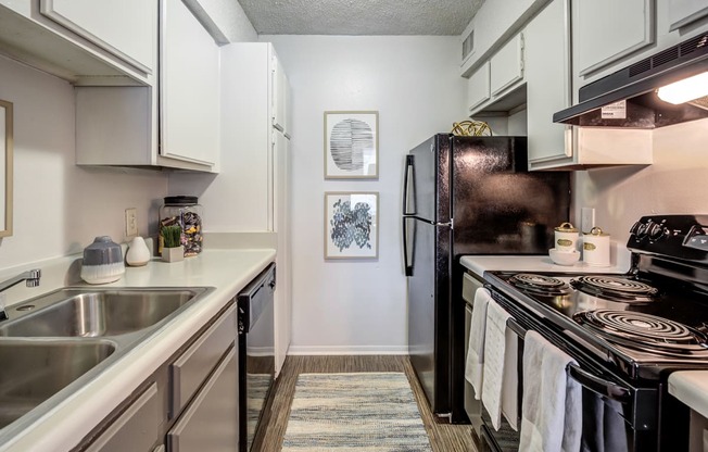 an updated kitchen with stainless steel appliances and white cabinets at The Hub at Baton Rouge, Baton Rouge, LA 70808