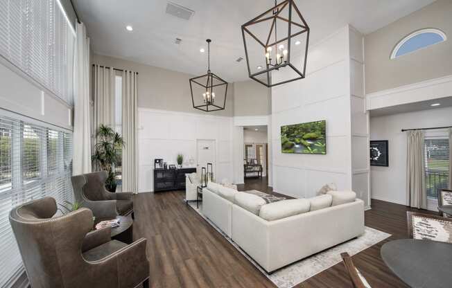 a living room with couches and chairs