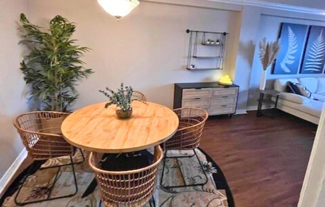 A dining room with a wooden table and chairs.