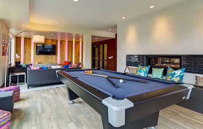 a game room with a pool table and a tv